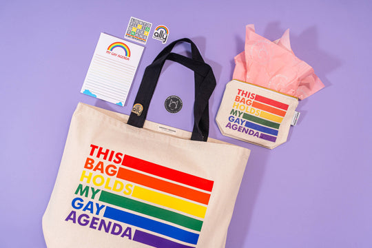Tote bag with rainbow design and text on a purple background