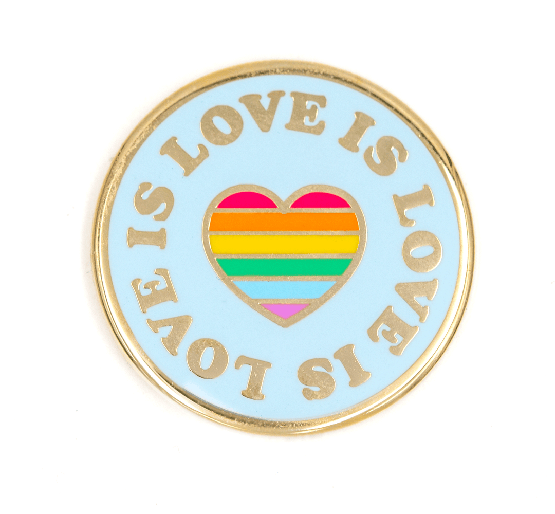 Pin with 'Love is Love' text and rainbow heart design on a light blue background
