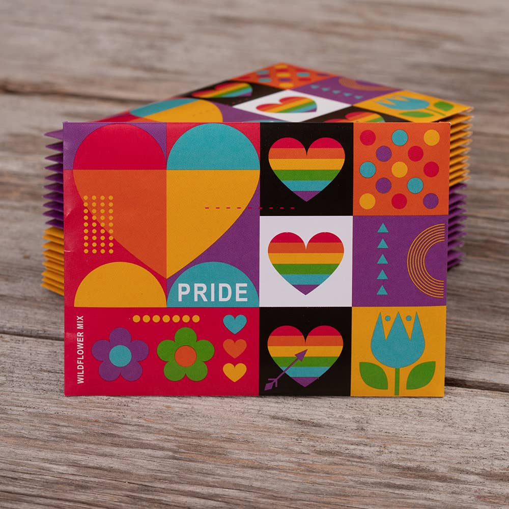 Colorful packaging with heart designs and the word 'Pride' on a wooden surface