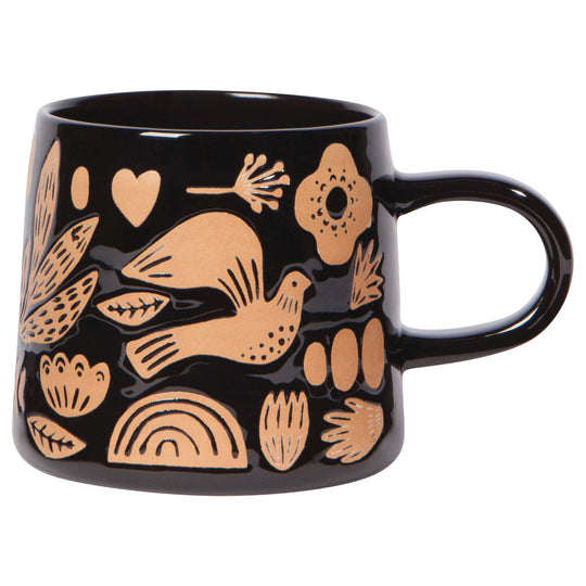 A black stoneware mug with beige and white bird and floral patterns.