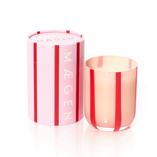Pink and red striped candle with matching packaging on a white background
