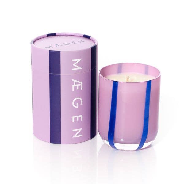 Pink candle with blue ribbons and matching pink packaging on a white background