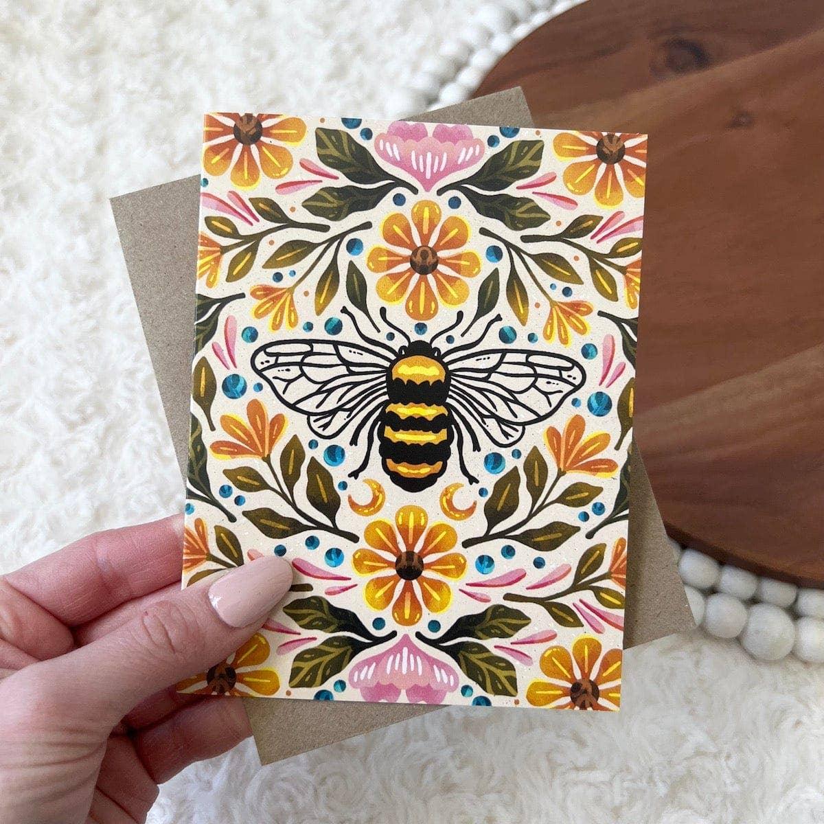 Bee floral greeting card with colorful flowers and leaves, perfect for curated gifts