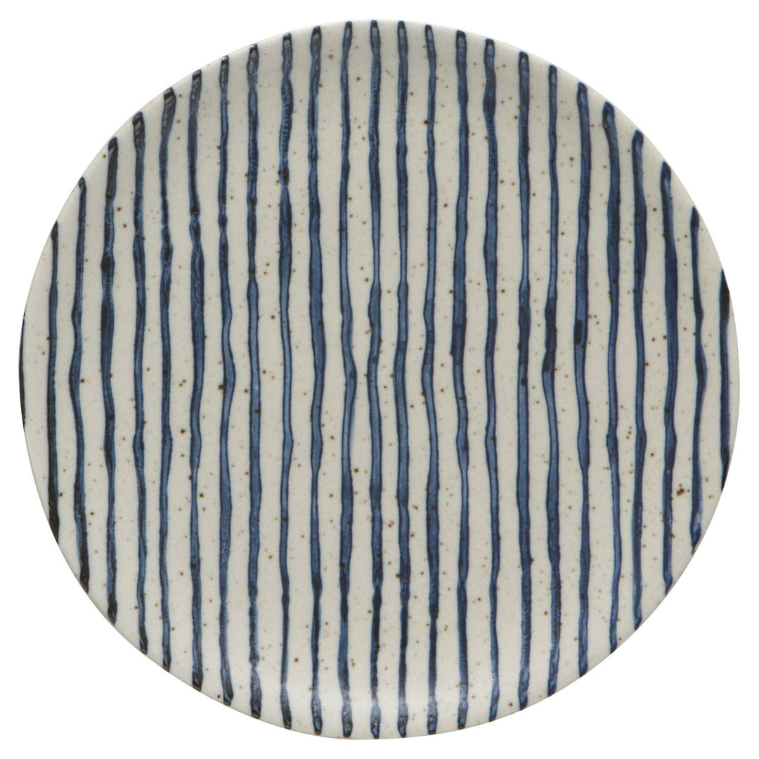 Round ceramic plate with blue vertical stripes on a white background