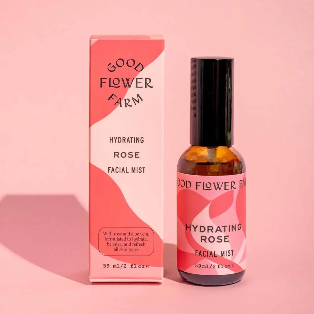 Good Flower Farm hydrating rose facial mist bottle and packaging on a pink background