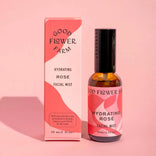 Good Flower Farm hydrating rose facial mist bottle and packaging on a pink background
