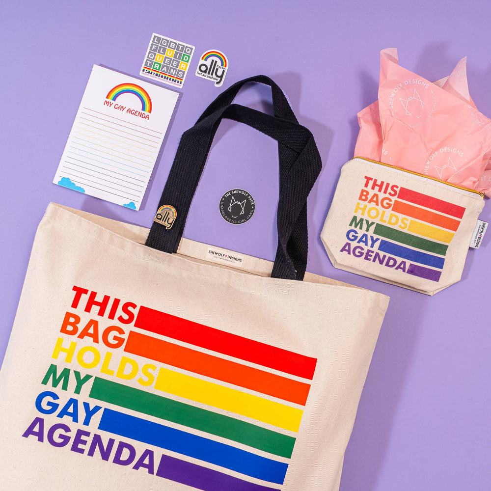 Tote bag with rainbow design and text on a purple background