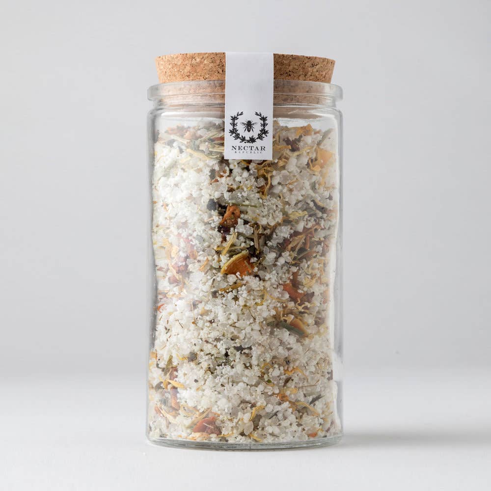 Glass jar with cork lid containing a mix of herbs and spices, branded 'Nectar'.