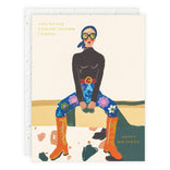 Birthday card with illustration of a person wearing sunglasses, colorful pants, and boots, with text 'You're the coolest human I know! Happy Birthday'.