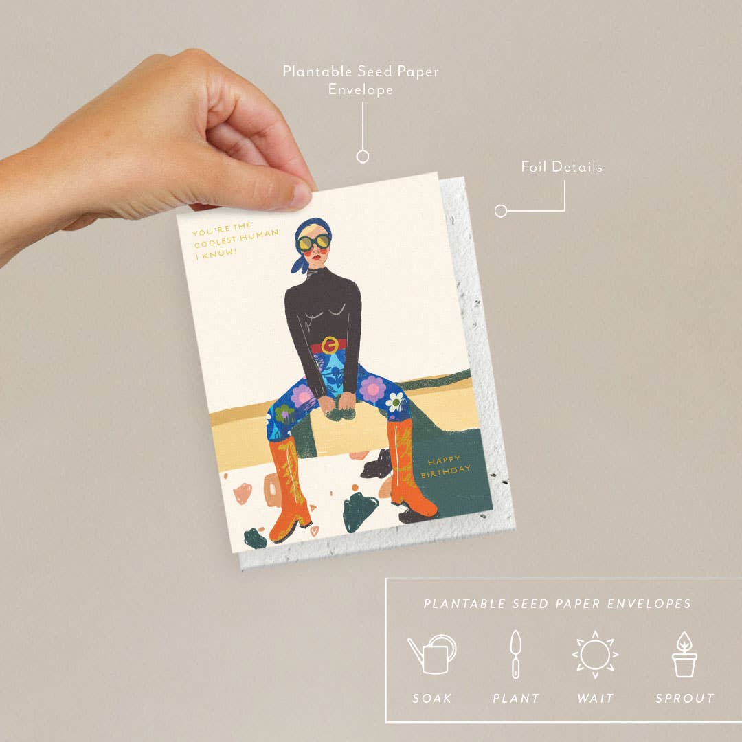 Hand holding a card with a person design, labeled 'Plantable Seed Paper Envelopes' and 'Foil Details'.