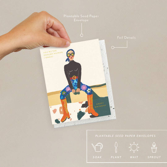 Hand holding a card with a person design, labeled 'Plantable Seed Paper Envelopes' and 'Foil Details'.