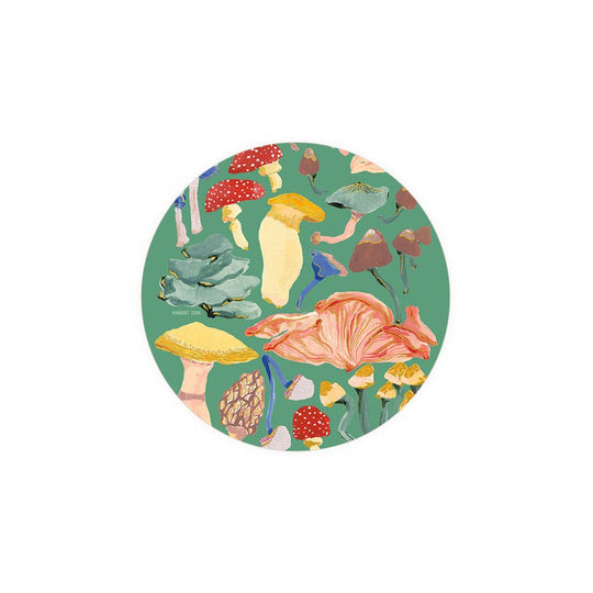 Round coaster with colorful mushroom design on a green background