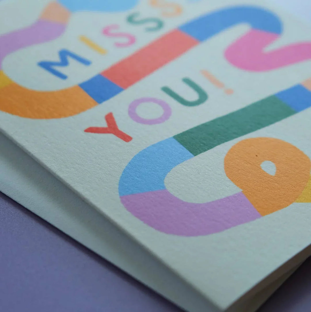 Colorful card with 'Miss You!' text on a purple background