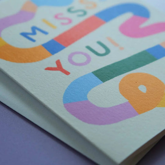 Colorful card with 'Miss You!' text on a purple background