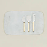 Elegant marble cheese board with gold-handled serving utensils for gourmet entertaining