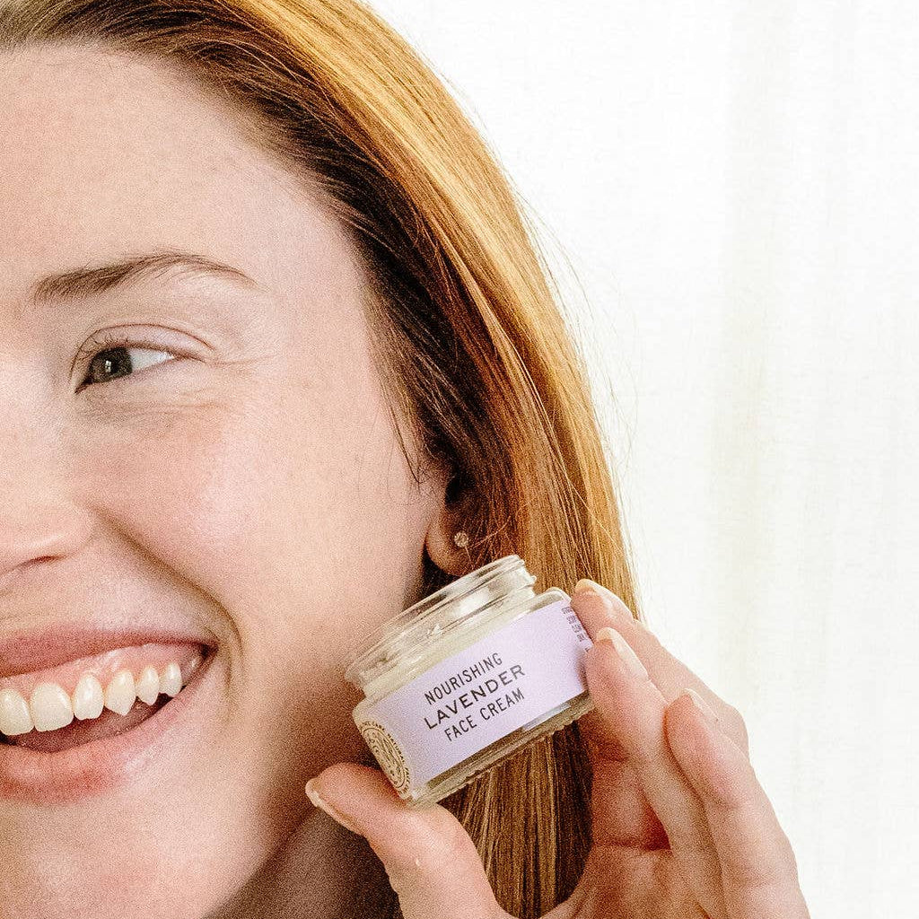 Woman holding a jar of cream with a white background