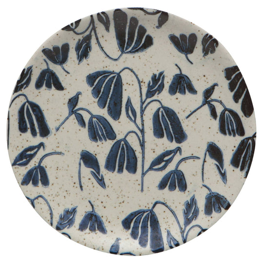 Round ceramic coaster with blue floral pattern on a white background