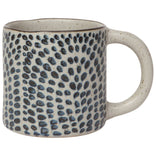 Ceramic mug with blue dot pattern on a white background
