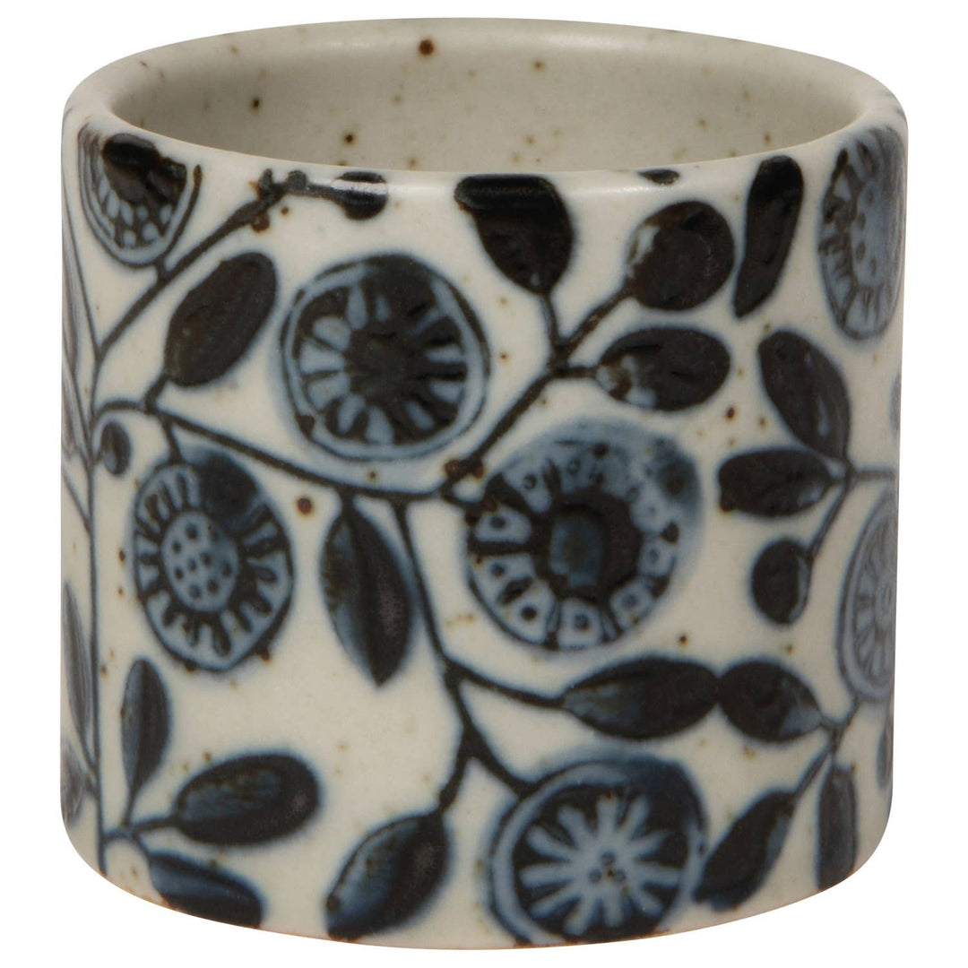 Ceramic napkin ring with blue floral pattern on a white background