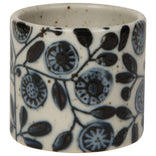 Ceramic napkin ring with blue floral pattern on a white background