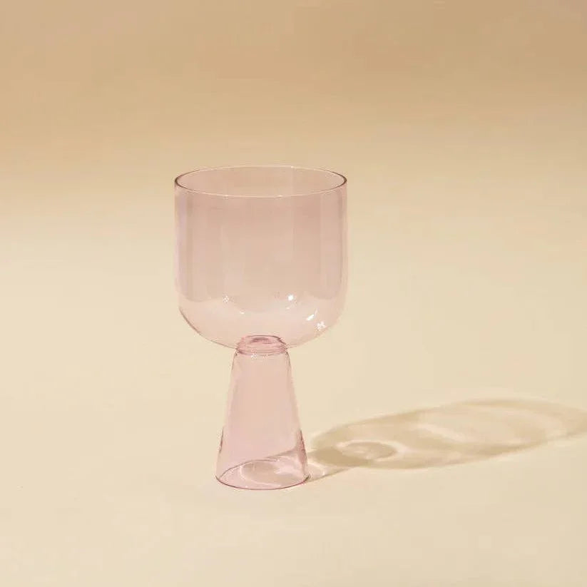 Pink glass on a beige background
