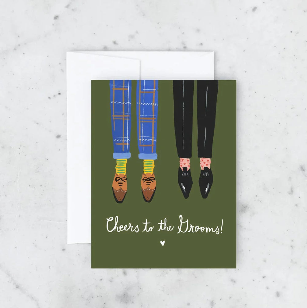 Greeting card with illustration of two pairs of feet in shoes and socks, with text 'Cheers to the brooms!' on a green background.