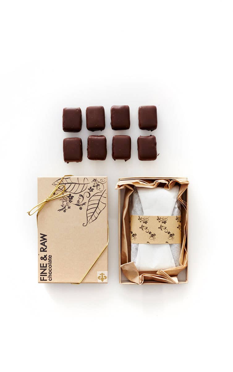 Chocolate bars in a decorative box with 'Fine & Raw' branding on a white background
