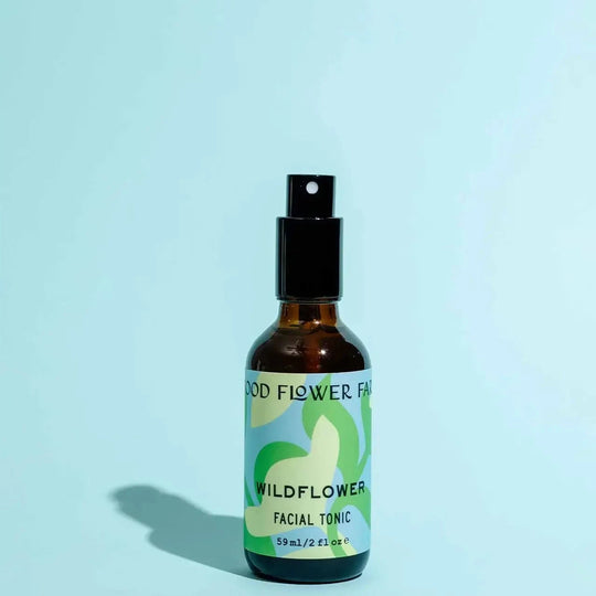 Bottle of Wildflower Facial Tonic on a light blue background