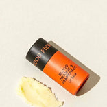 Lip balm stick with 'Good Flow' branding on a beige background