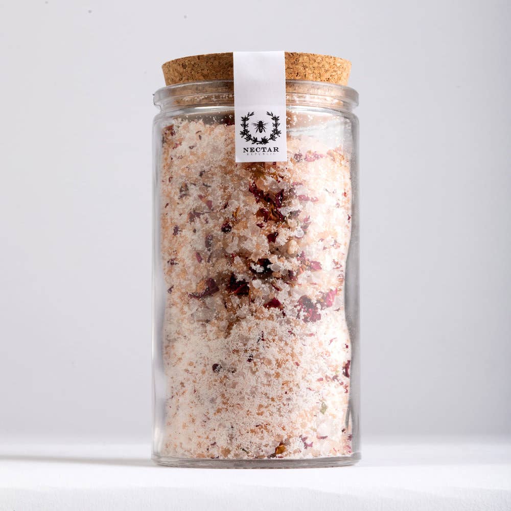 Glass jar with cork lid containing a bath salt mix, branded 'Nectar'.