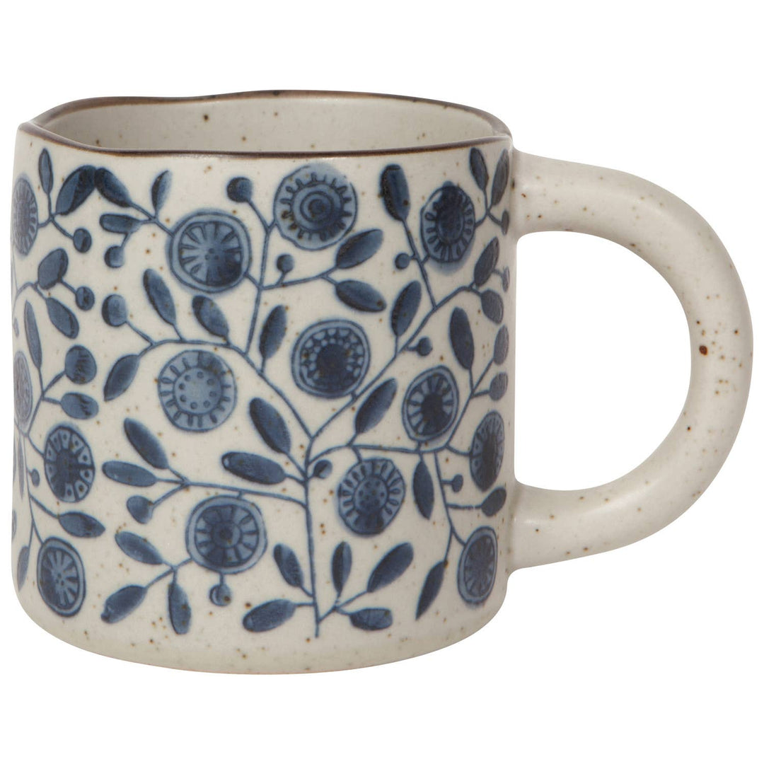 Ceramic mug with blue floral pattern on a white background