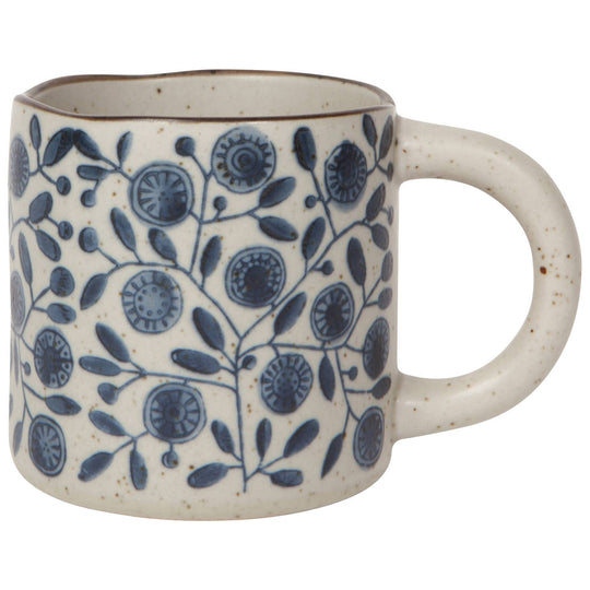 Ceramic mug with blue floral pattern on a white background
