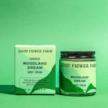 Good Flower Farm Woodland Dream body cream and packaging on a green background