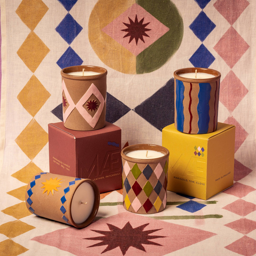 Colorful candles on geometric-patterned fabric