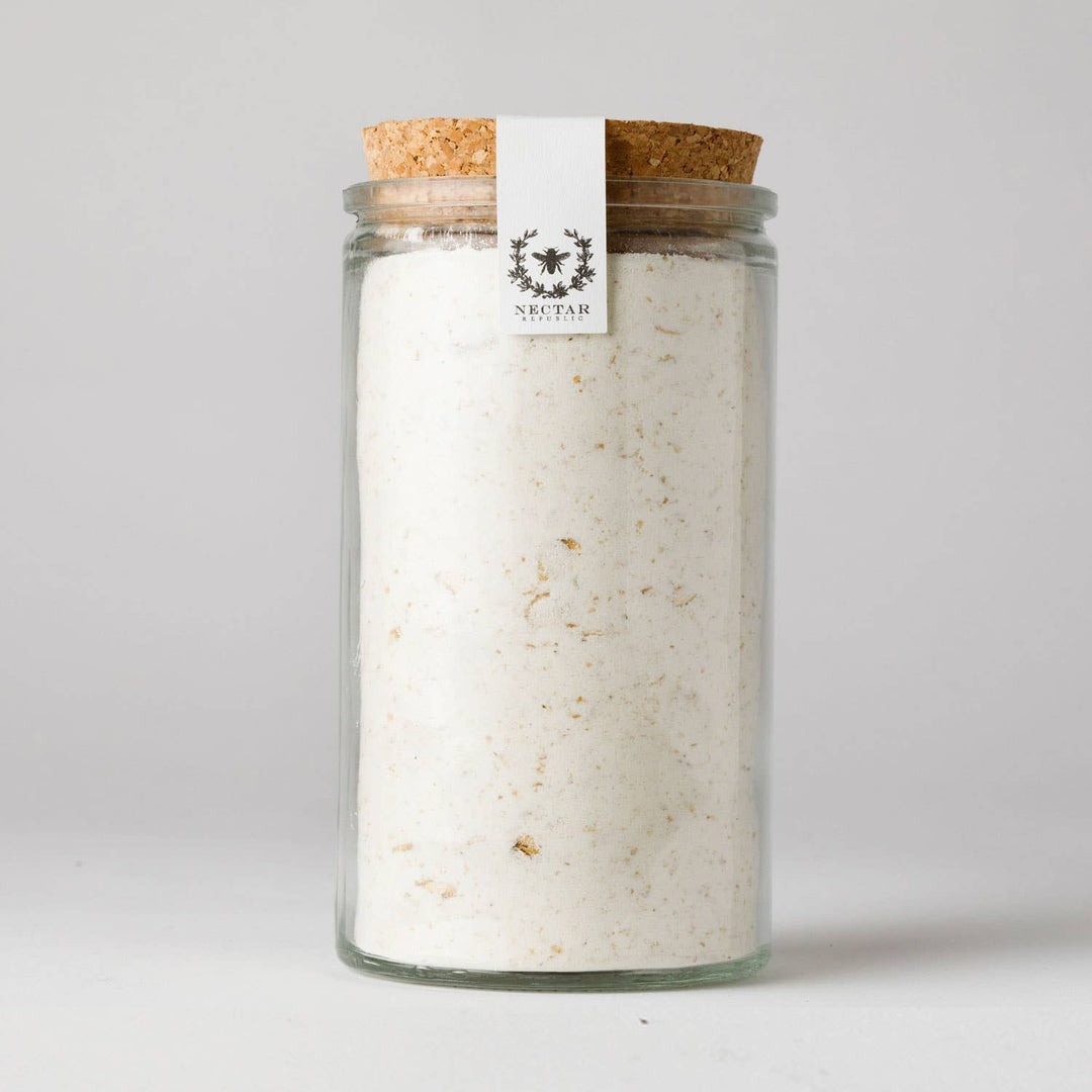 Glass jar with cork lid containing a white powder, branded 'Nektar' on a light gray background