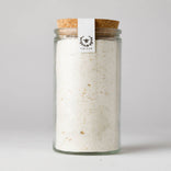Glass jar with cork lid containing a white powder, branded 'Nektar' on a light gray background