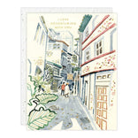 Illustrated card with a street scene and text 'I love adventuring with you'.