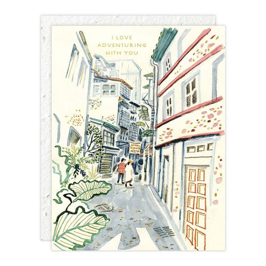 Illustrated card with a street scene and text 'I love adventuring with you'.