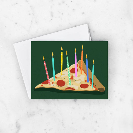 Birthday card with a slice of pizza and lit candles on a white marble background
