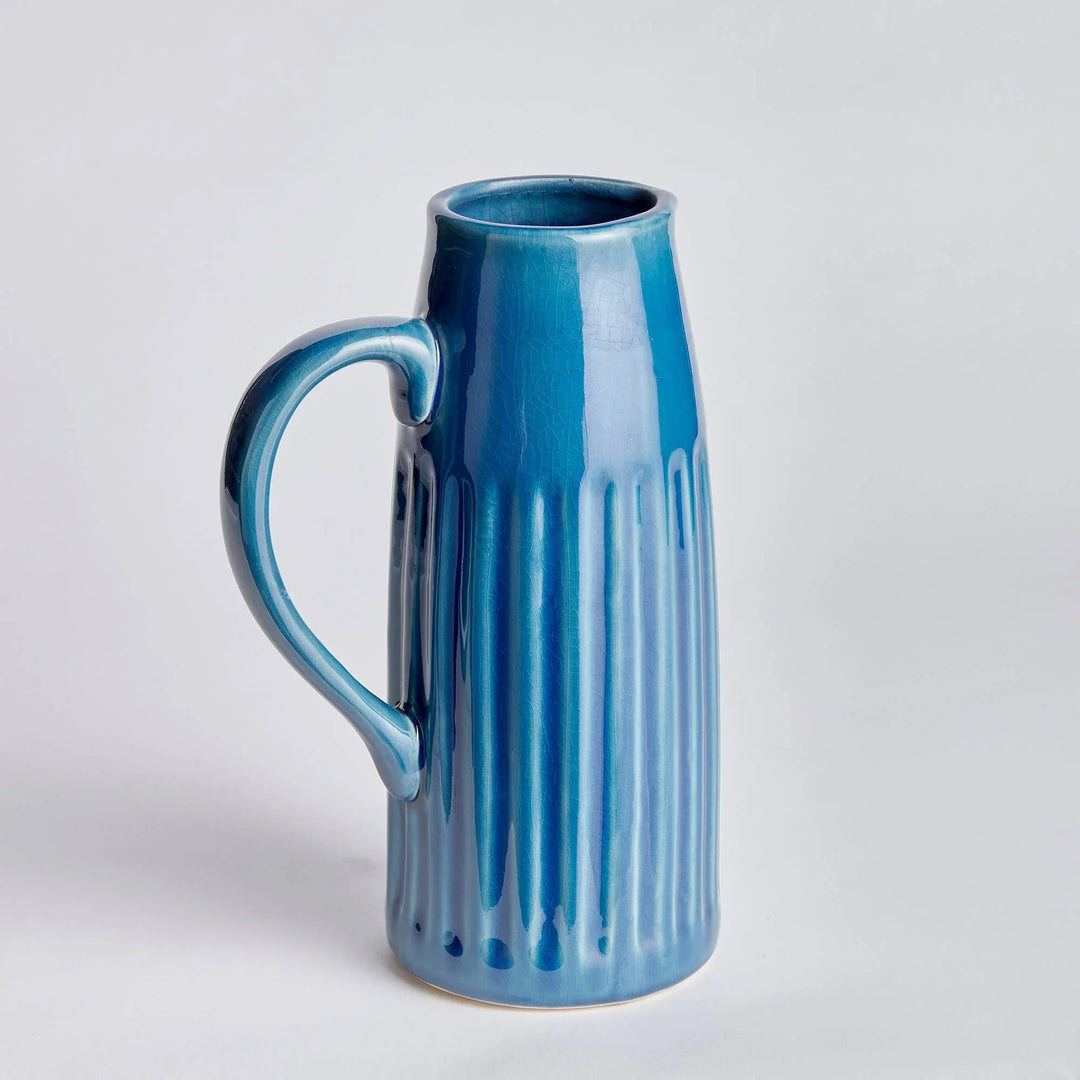 Blue ceramic vase with handle and vertical ridges, perfect for floral arrangements