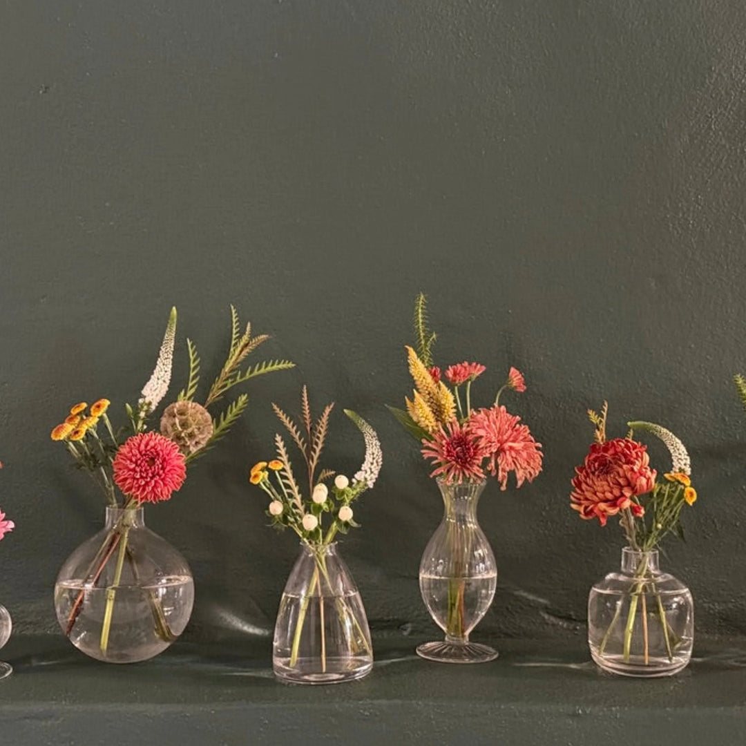 Elegant seasonal flower arrangements in glass vases, perfect for home decor or gifting.