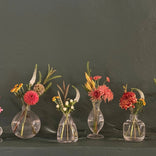 Elegant seasonal flower arrangements in glass vases, perfect for home decor or gifting.