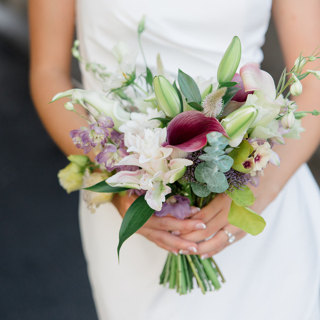 Bouquet held by a person in a white dress