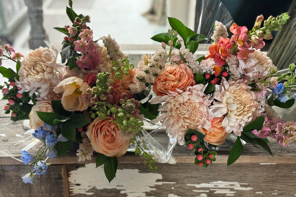 Floral arrangements on a wooden surface with a blurred background