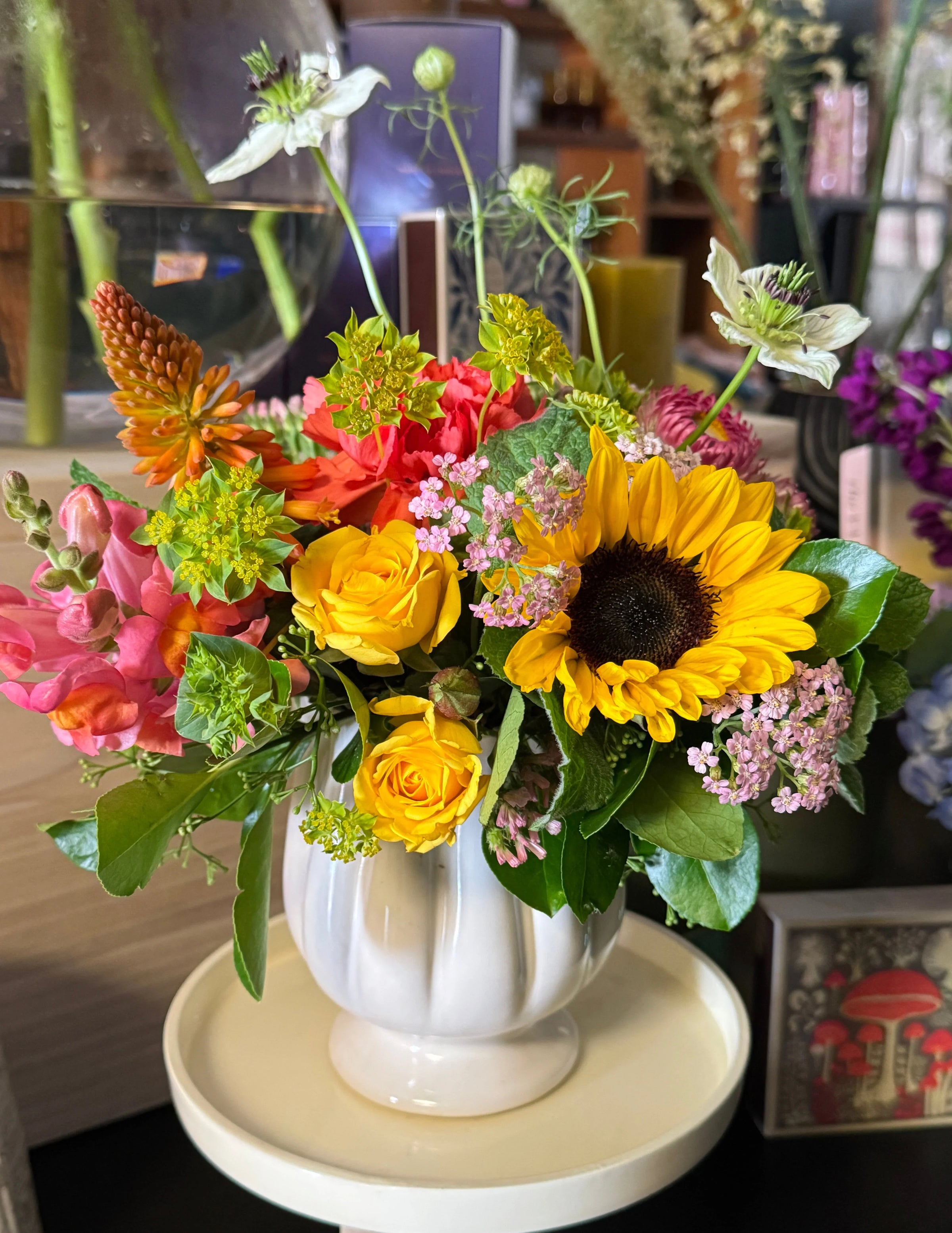 Bouquet of flowers with sunflowers and roses on a table.