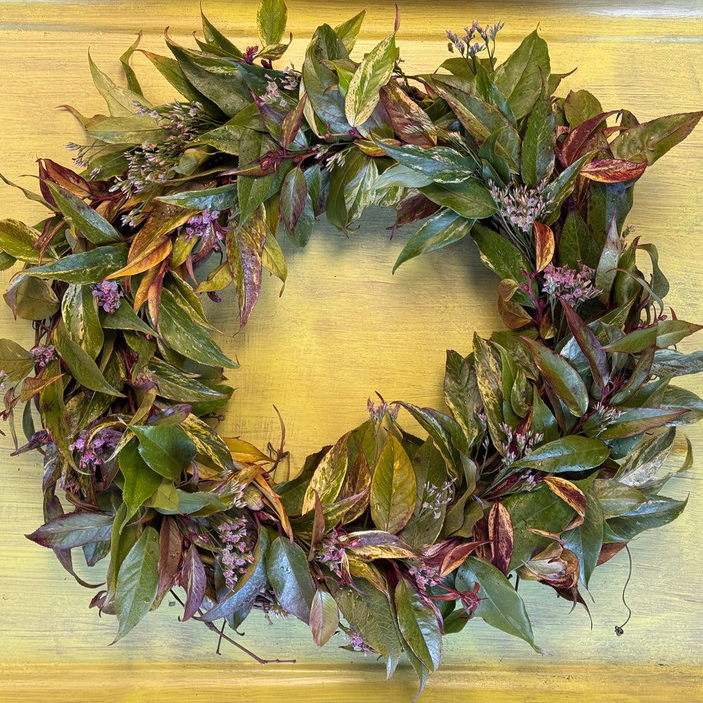 Green leaf wreath on a gold background