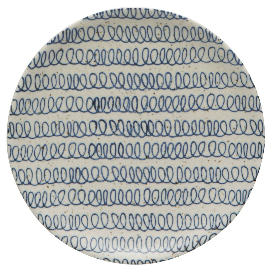 Round ceramic plate with blue wave pattern on a white background