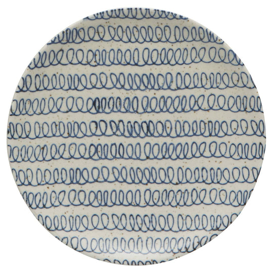 Round ceramic plate with blue wave pattern on a white background