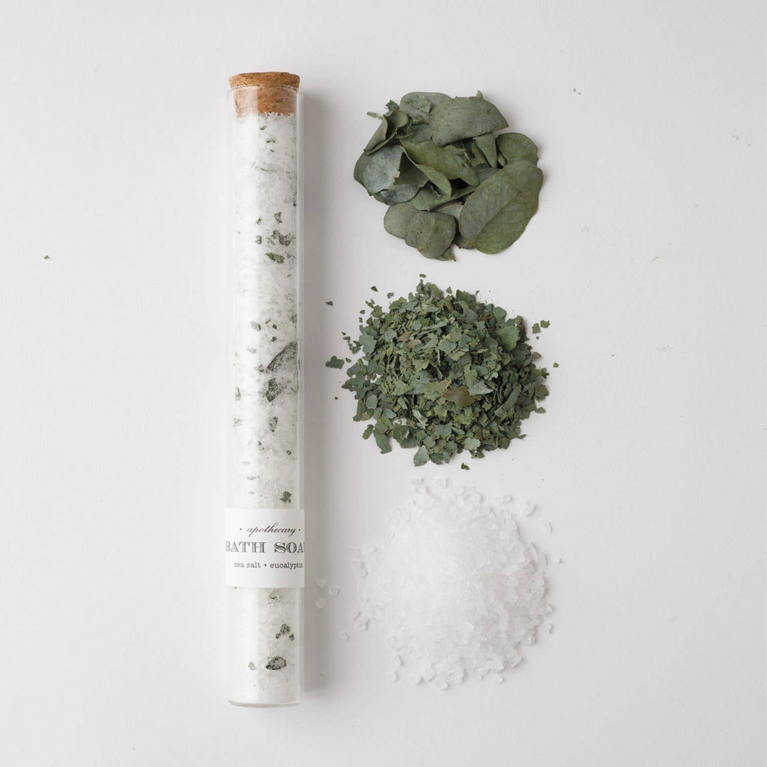 Bath salt with eucalyptus leaves and salt on a white background