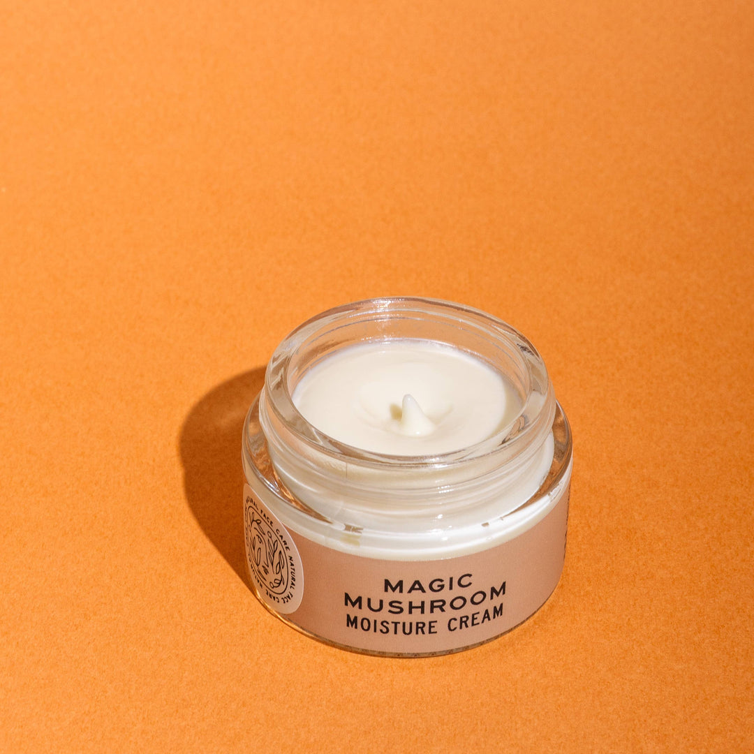 Jar of 'Magic Mushroom Moisture Cream' on an orange background